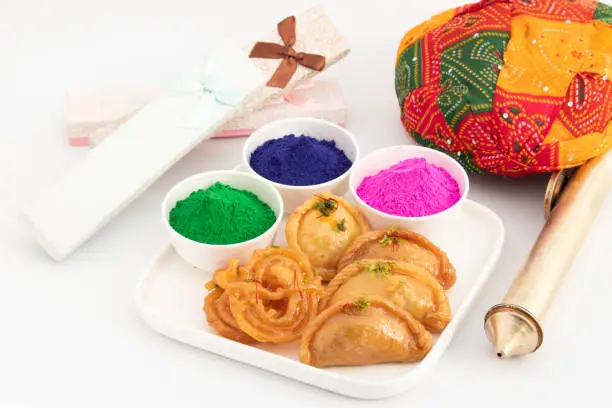 Photo of Assorted Indian Mithai Jalebi, Jilebi, Zalebi, Gujiya, Gujia, Karanji, Pedakiya, Basundi, Gughra, Chandrakala And Colorful Herbal Holi Color Powder Gulal, Rang, Abir Or Abeer Decorated For Celebration