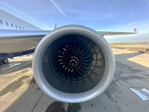 London, United Kingdom - February 2023: Close up view of one of the Rolls Royce Trent XWB-97 jet engines on a British Airways Airbus A350 passenger jet (registration G-XWBM)