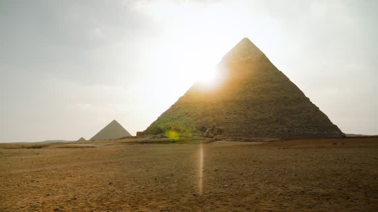 View of the Pyramids of Giza with sun flare on the edge