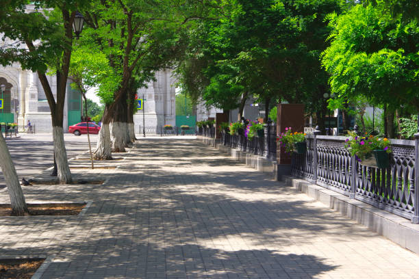 Astrakhan city street with green trees.