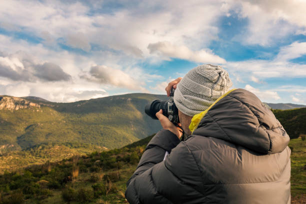 istock Photographer taking picture in mountains 1465375303