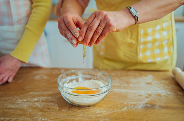 istock Woman breaking egg for the baking mixture 1465375328