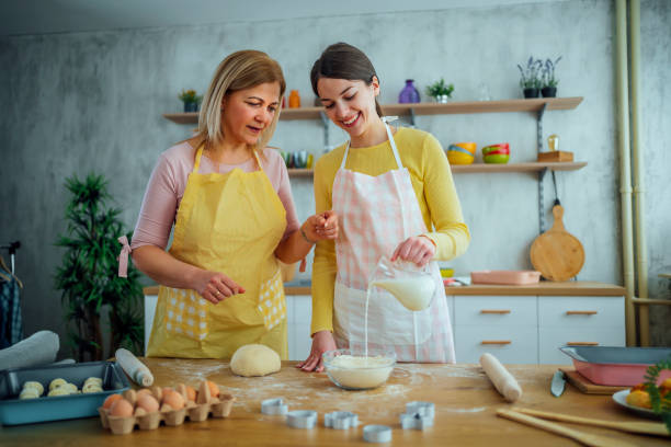 istock Mother and daughter preparing dough 1465376278
