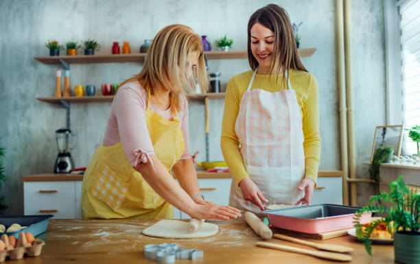 istock Mother and daughter preparing dough 1465377064