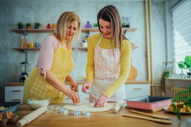 istock Mother and daughter preparing cookies 1465377107