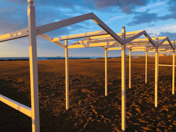 istock Wooded White structures on the beach at Sunset 1465377499