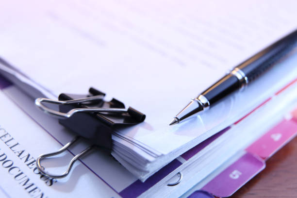 istock Ballpoint Pen Resting On Top Of Stack Of Documents 1465378057