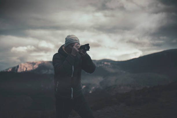 istock Photographer taking picture in mountains 1465378377