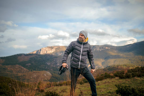 istock Photographer taking picture in mountains 1465379667