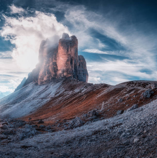 istock Mountain pass and blue sky with clouds at sunny day in autumn. Beautiful dramatic landscape with rocks, alpine mountains, stones, path, grass on hills. Tre Cime, Dolomites, Italy. Colorful scenery 1465384997