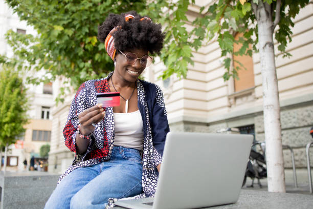 istock Cheerful  young woman doing online shopping 1465385015