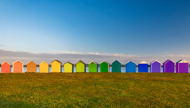 multi coloured beach huts at hamworthy in poole, dorset - bournemouth imagens e fotografias de stock