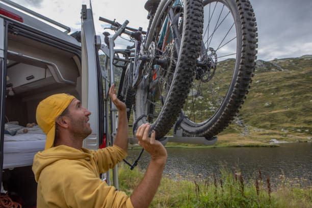istock Man loading mountain bikes on the back of a van 1465414169