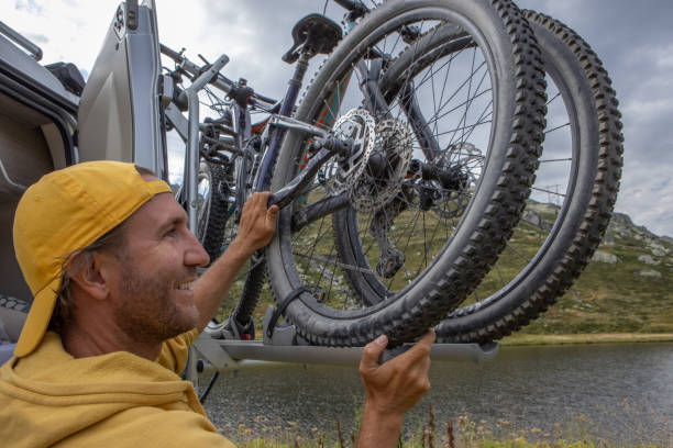 istock Man loading mountain bikes on the back of a van 1465414172