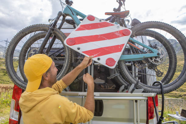 istock Man loading mountain bikes on the back of a van on a bike rack 1465414179