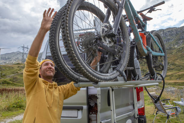 istock Man loading mountain bikes on the back of a van on a bike rack 1465414184