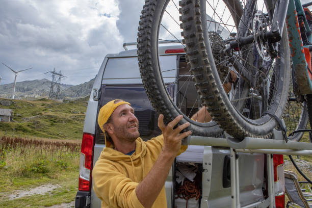 istock Man loading mountain bikes on the back of a van 1465414211