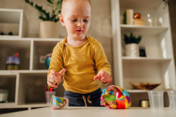 istock Toddler child playing with modeling clay in a kindergarten or ho 1465415637