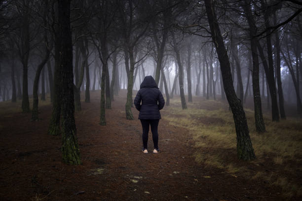 istock Woman in forest with fog 1465418430