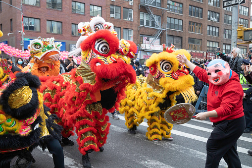 February 23, 2023, New York City, NY: Colorful Chinese dragons and a clown march down Mott Street during the annual Chinese New Year Parade.