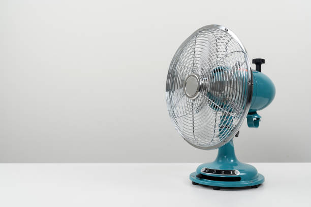 istock Vintage blue tabletop fan isolated on a white background 1465424351