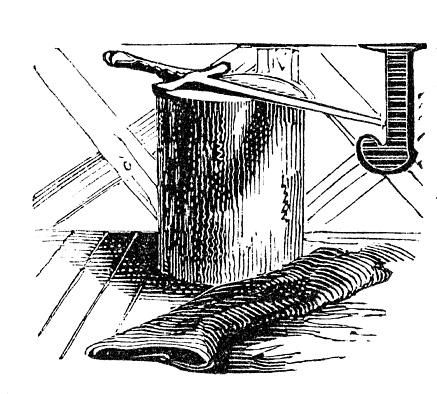 Capital J. A sword is on a tree stump and a bolt of cloth. Woodcut engraving published 1846. Original edition is from my own archives. Copyright has expired and is in Public Domain.