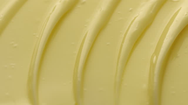 Crane macro texture of yellow face cream with mango butter