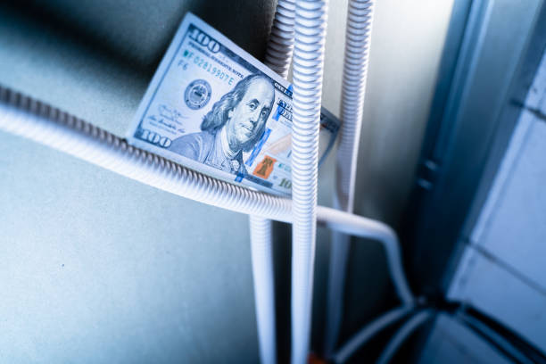 istock One hundred dollars lie on the electrical wiring in the corrugated pipe inside the interior wall. Corrugated wiring in a frame plasterboard wall. Payment for electrical services 1465441220