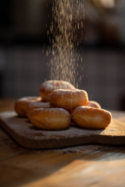 Sprinkling sugar powder on Japanese donuts.