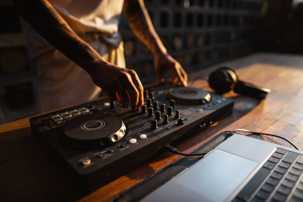 istock DJ playing music,Man using mixing desk at party out in the evening 1465441329