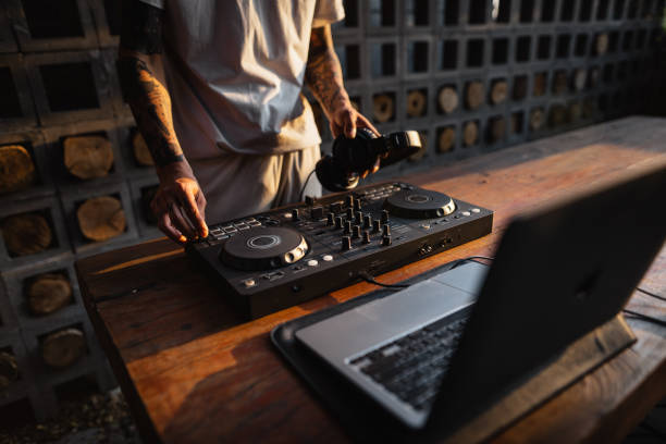 istock DJ playing music,Man using mixing desk at party out in the evening 1465441405