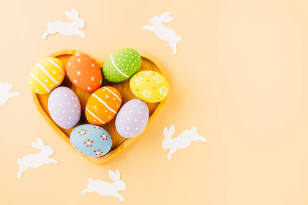 istock Overhead easter eggs with rabbit paper cut in shape heart isolated on pastel background 1465444063