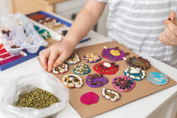 istock Childish hands decorated plasticine shape natural beans seeds imagination early development closeup 1465445087