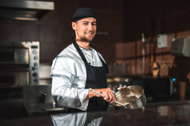 istock Preparing a Dish, Male Chef in Kitchen 1465447024