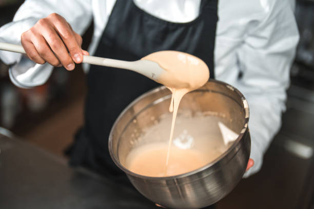 istock Male Hand and Spoon Checking Consistency 1465447033