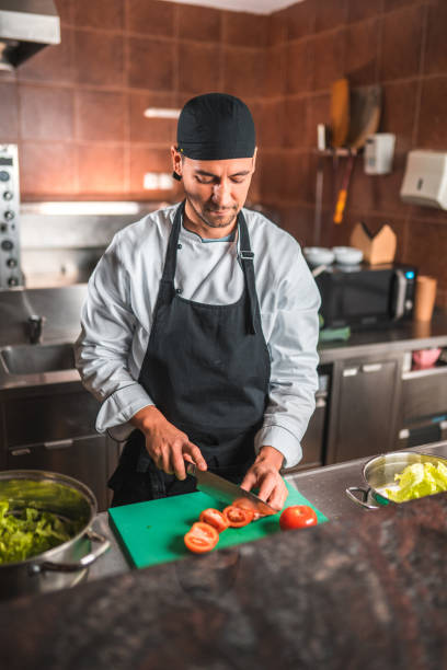 istock Japanese Chef Dices Tomatoes for Recipe 1465447072