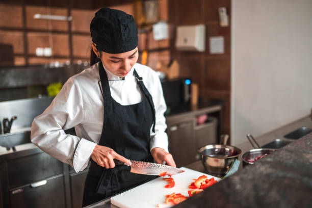 istock Preparing Food, Experienced Female Chef in Kitchen 1465447120