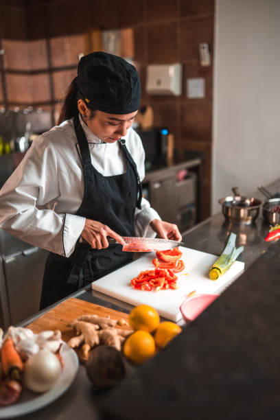 istock Uniformed Vietnamese Female Chef Gets the Red Pepper Sliced 1465447123