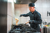 Expert Male Cook Making a Noodle Asian Dish