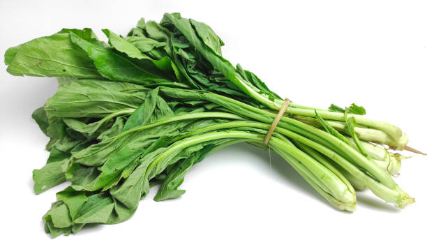 a bunch of green vegetables on a white background. green mustard for cooking