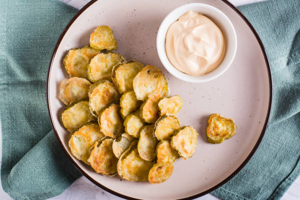istock Fried pickles and sauce on a plate. American snack. Top view. Closeup 1465453461