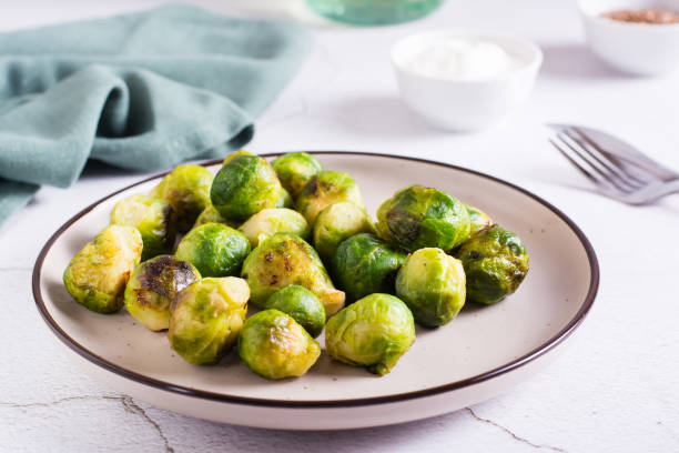 istock Roasted Brussels sprouts on a plate on the table. Vegetarian diet. 1465454349