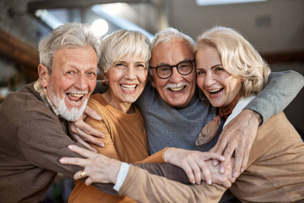 istock Happy mature friends embracing at home. 1465454364