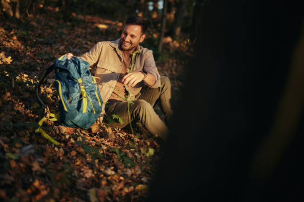 istock Happy male backpacker resting in the woods. 1465455869