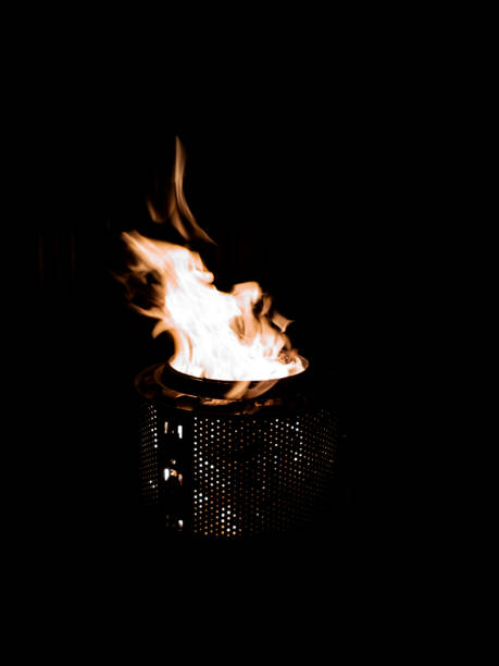 The fire dancing in a laundry drum fire pit. stock photo