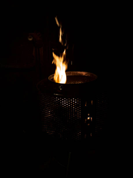 The fire dancing in a laundry drum fire pit. stock photo