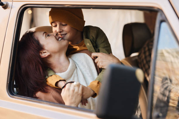 istock Loving mother and son enjoying while traveling by a van. 1465456684