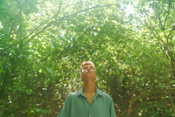 istock Portrait of young man in tropical forest 1465456904