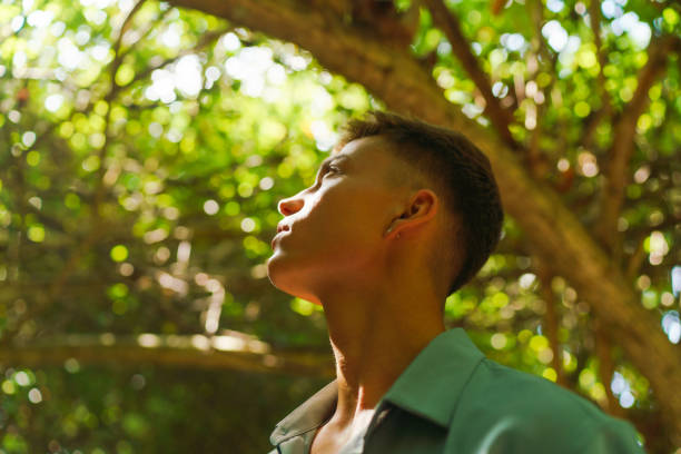 istock Portrait of young man in tropical forest 1465457606