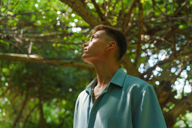 istock Portrait of young man in tropical forest 1465457609
